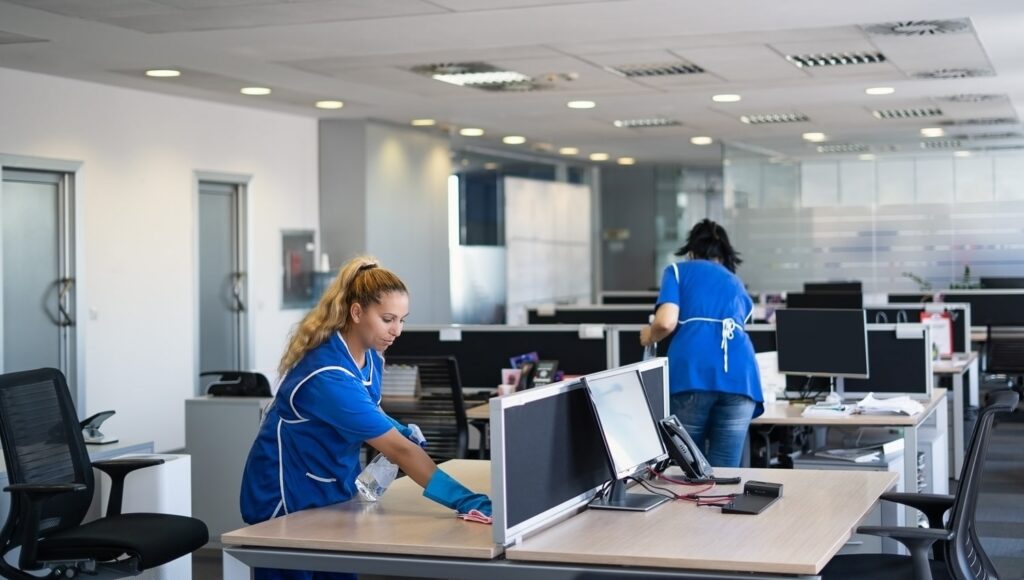 Office cleaners working in a commercial workspace in New Zealand